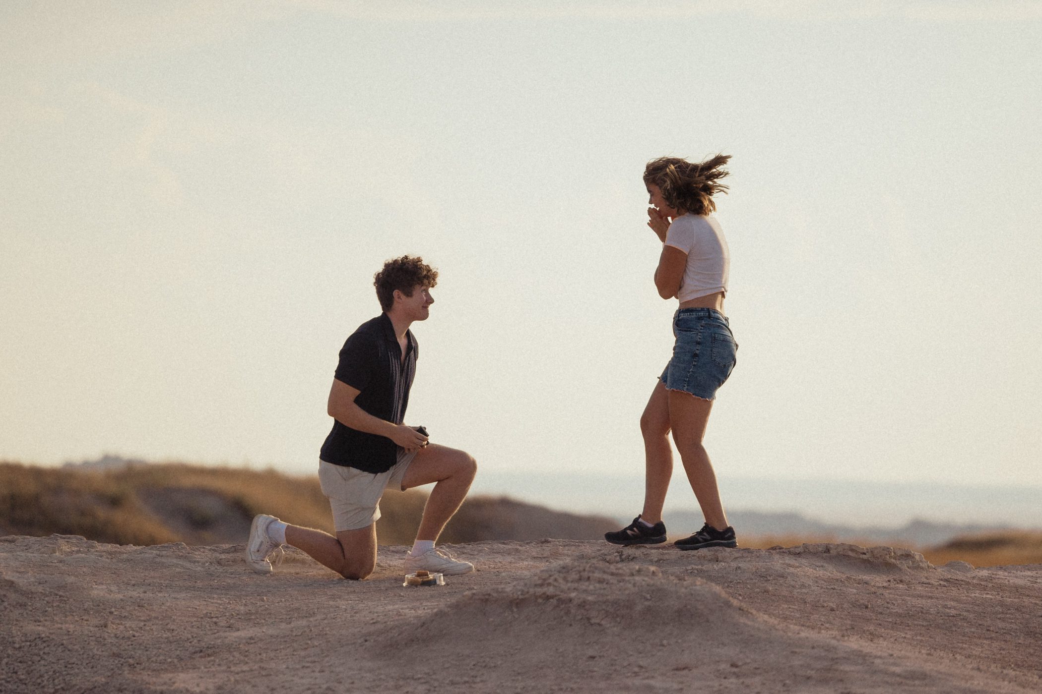 Surprise proposal at Pinnacle Point in Badlands National Park with stunning rock formations in the background